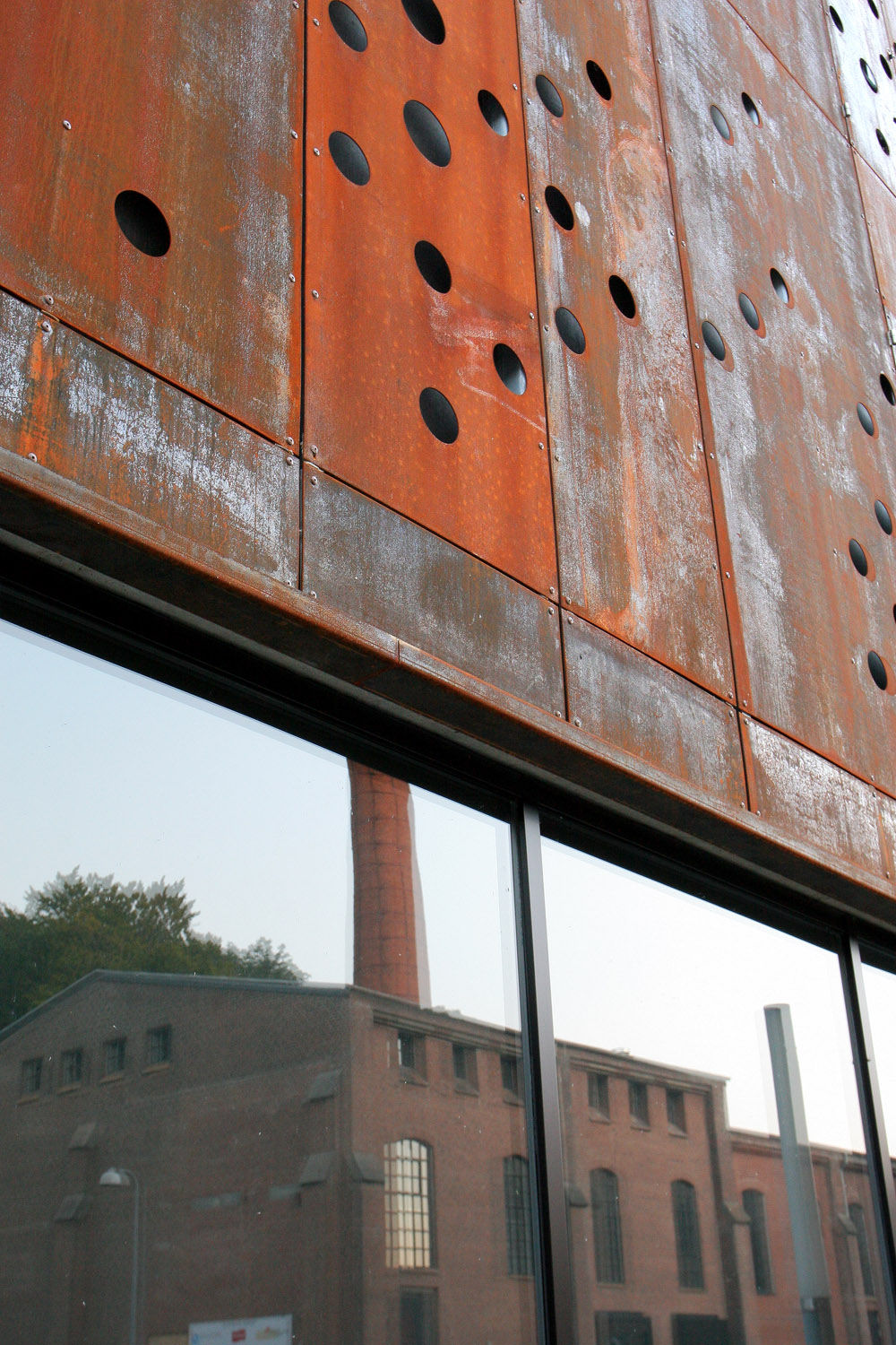 Perforated rustred steel panels covering whole façade [491] filt3rs